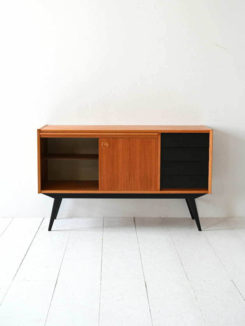 Scandinavian teak sideboard with black-c details.